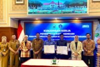 Dirut Perumda Tugu Tirta Kota Malang, Priyo Sudibyo dan Perumda Air Minum Tirta Anoa Kota Kendari (tengah) menunjukkan PKS yang telah ditandatangani. (foto : Ist)