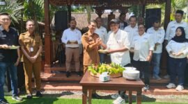 Sekretaris SMSI Malang Raya, Dadang Dwi Tanto (Dudung) memberikan potongan tumpeng kepada Kadis Kominfo Kota Malang, Muhammad Nur Widianto. Foto (Kim/ngalamutas.com)